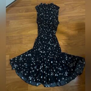 selling a black dress with tiny flowers all over. mid length
